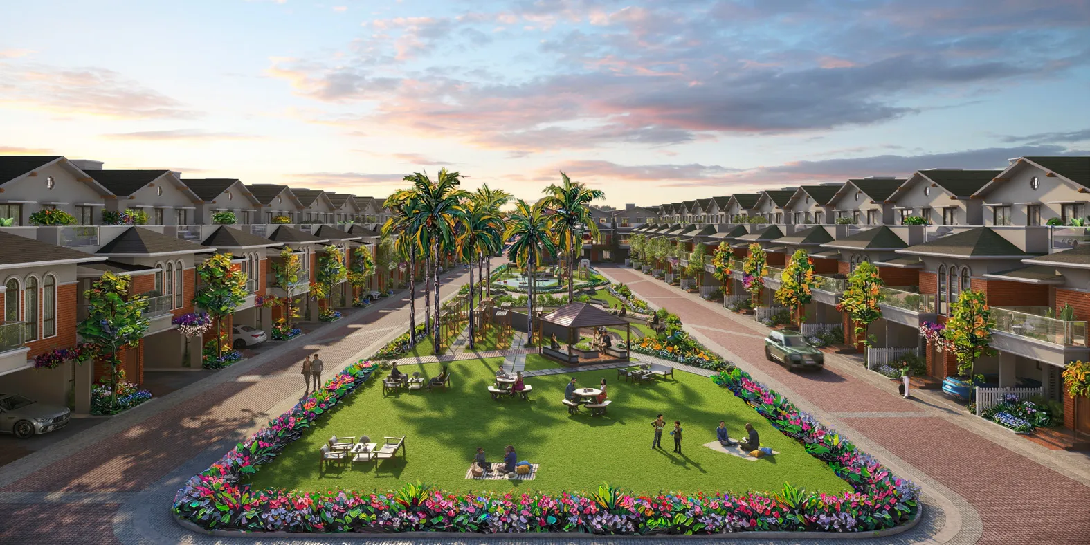 Aerial view of the central green boulevard lined with red-brick villas at NVT Villas, Varthur